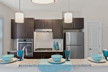 A kitchen with a large island and stainless steel appliances